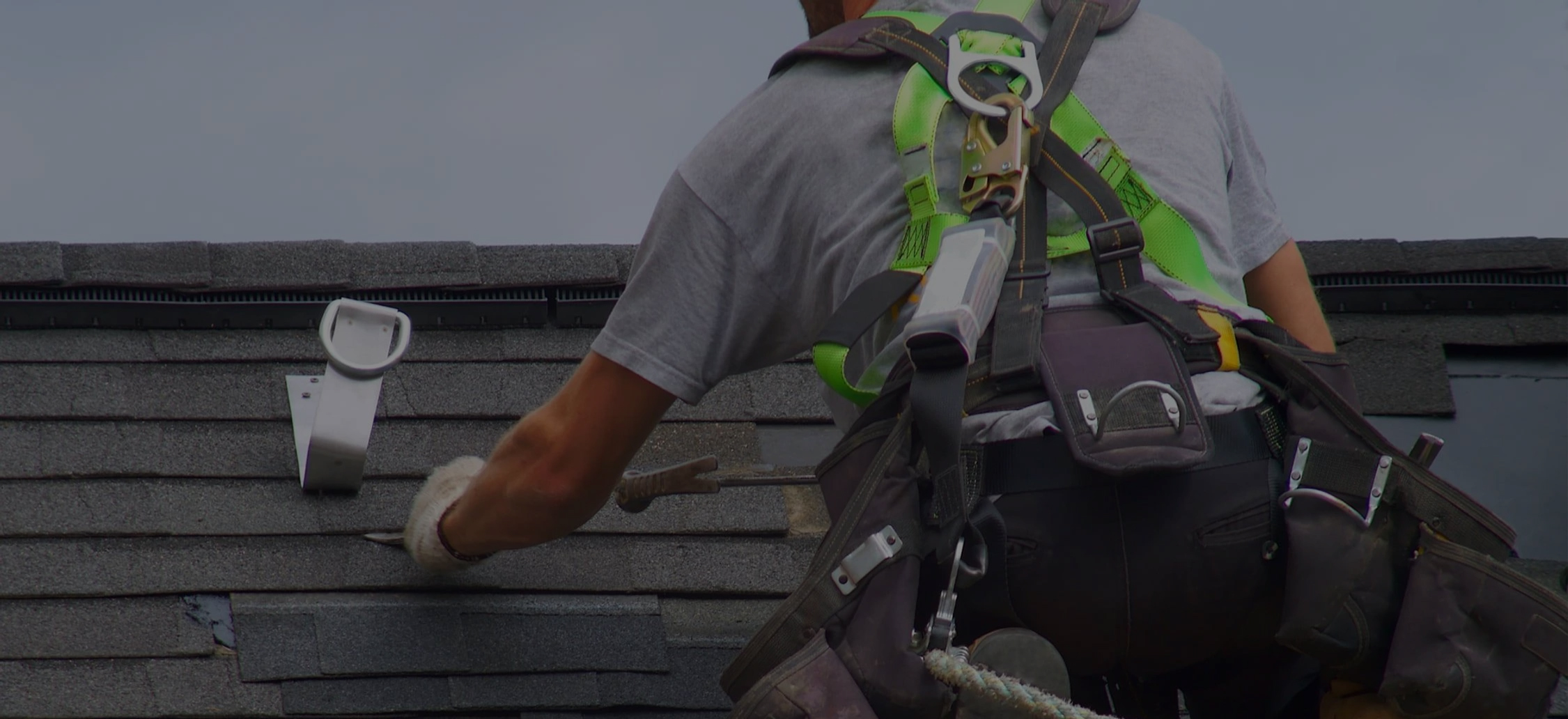 Roofing installed on top of a roof, removing old, cracked shingles.