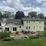 james_hardie_square_1 Photo of a large home with roofing, siding, and patio, with construction materials.